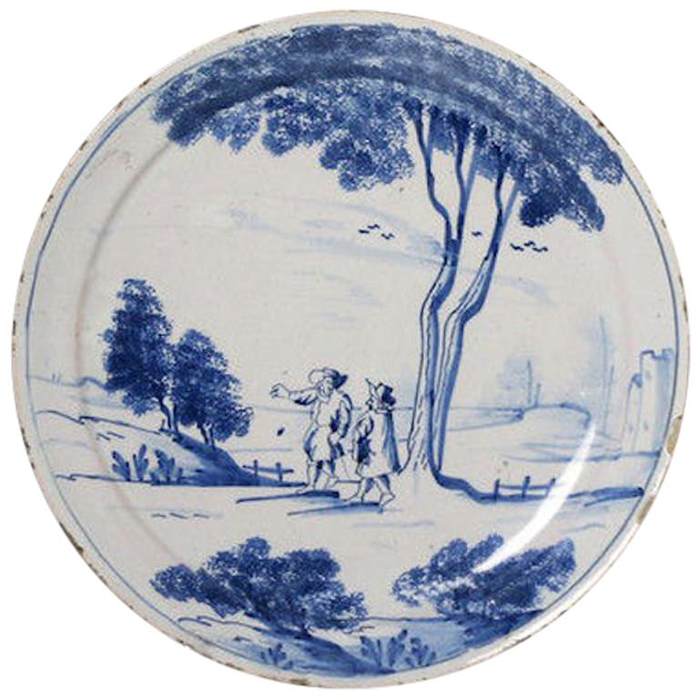 English Delftware Plate with Scene of Two Figures in a Rural Landscape, 1740 For Sale