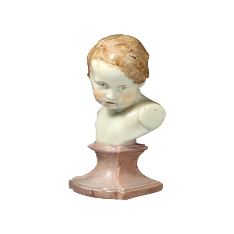 Staffordshire Pearlware Bust of a Putto on a Socle Base, Early 19th Century For Sale