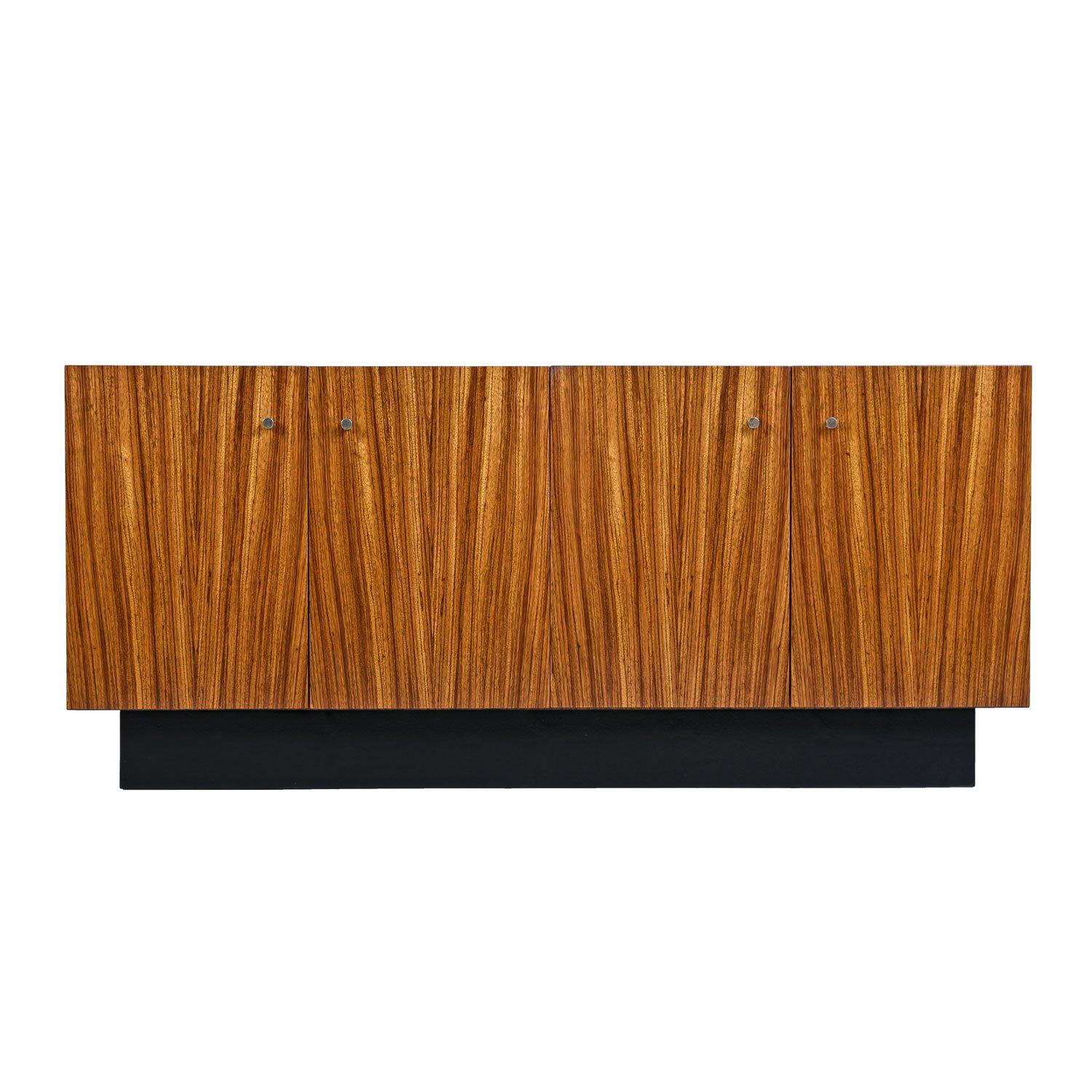 Brilliant simplicity and captivating exotic materials intersect on this Milo Baughman credenza. Made by Thayer Coggin, circa 1970s. The spare form rejects decorative embellishments, allowing the zebra wood veneer to dazzle the eye. The cabinet sits