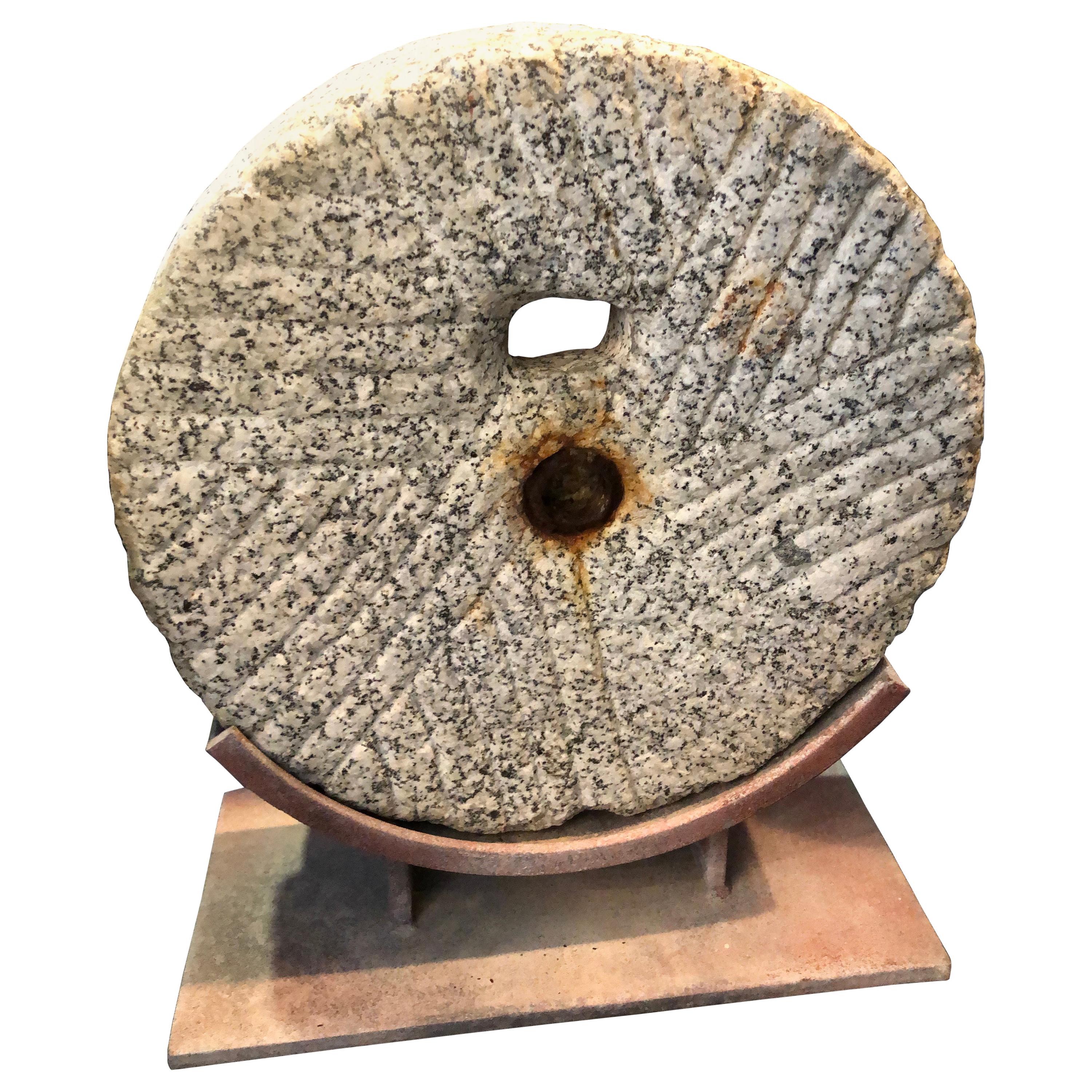 Primitive Grinding Stone Wheel on Iron Display