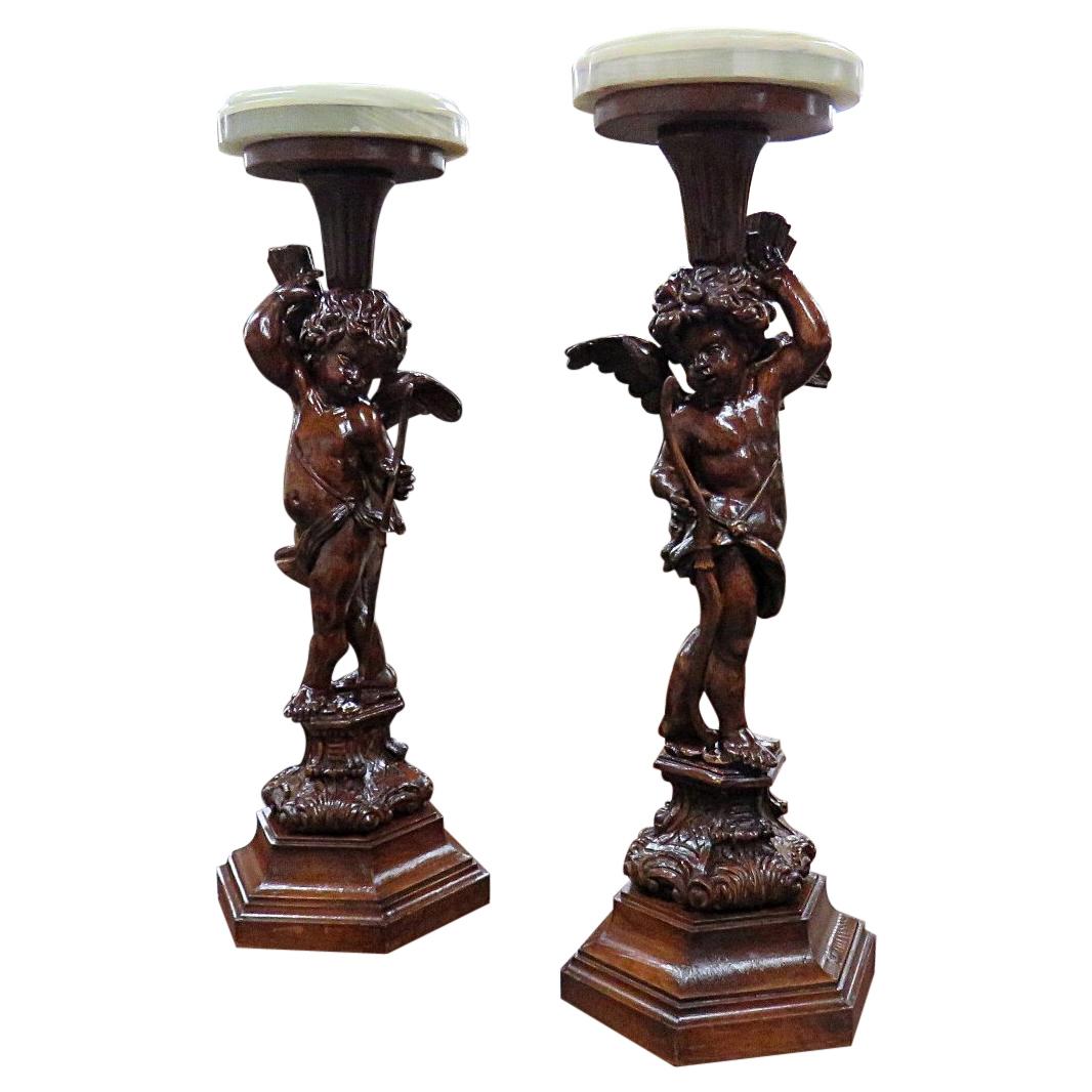 Pair of Carved Walnut Renaissance Style Winged Cherub Putti Onyx Top Pedestals