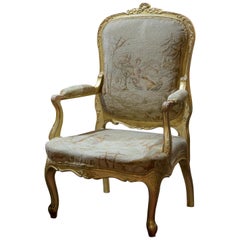 Carved giltwood Louis XVI style fauteille with original tapestry upholstery