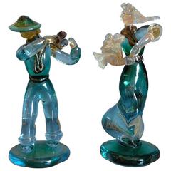 Two Murano 1940s solid coloured glass rural figurines.