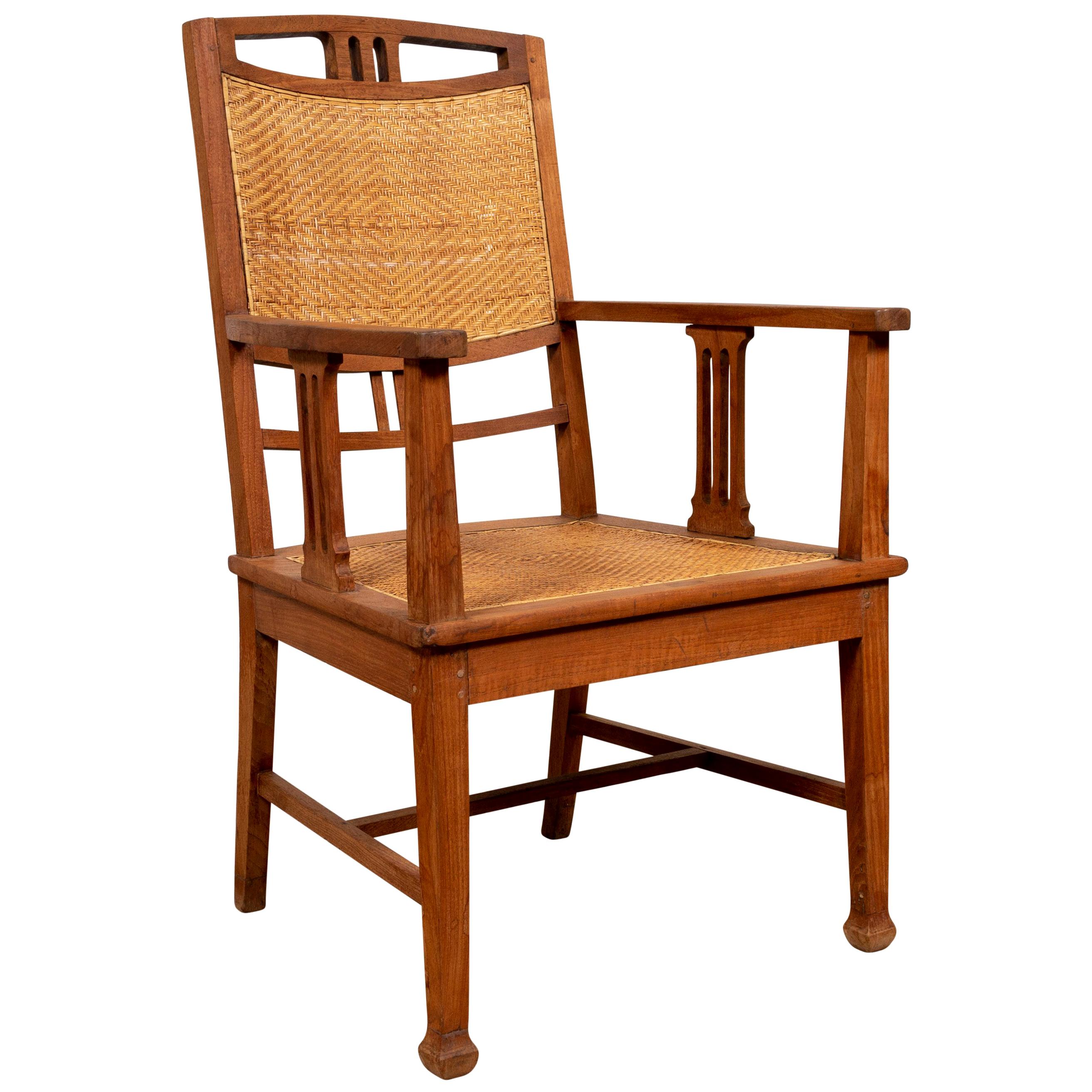 Dutch Colonial Javanese Teak Armchair with Rattan and Triglyph Inspired Motifs For Sale