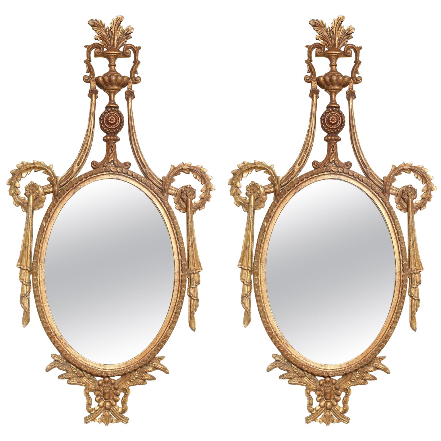Pair of Classical-form Italian Carved Giltwood Oval Mirrors