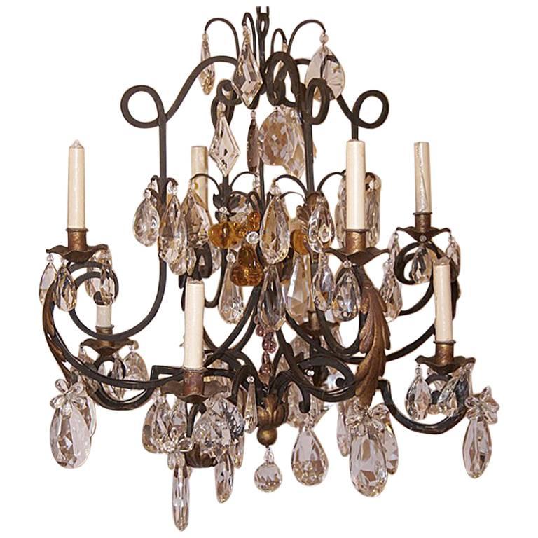 A circa 1930’s Italian wrought iron chandelier with gilt details, crystals and Murano glass fruit pendants.

Measurements:
Drop: 31″
Diameter: 26″