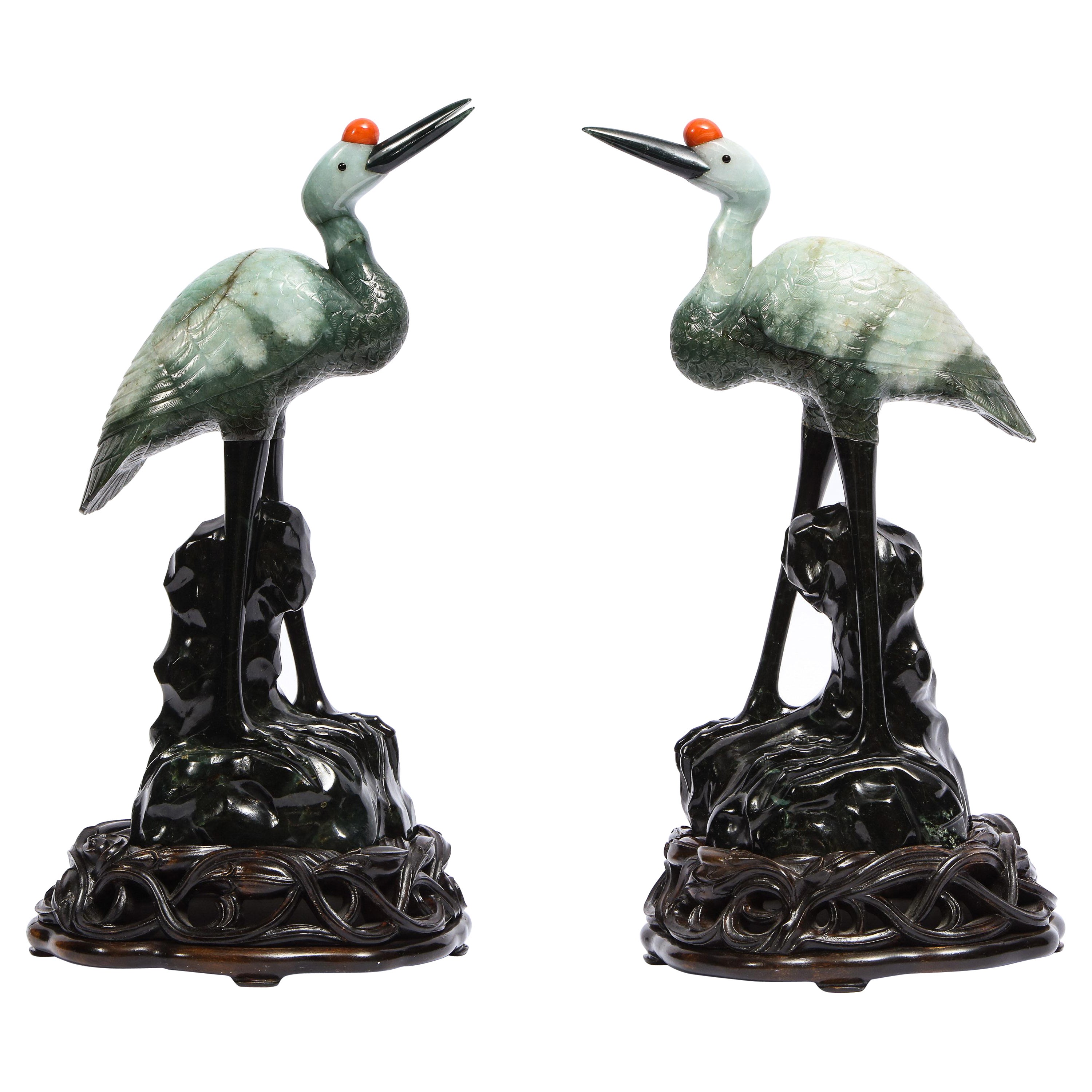Pair Chinese Mottled Light Green Jadeite Carvings, Cranes on Carved Wood Stands For Sale