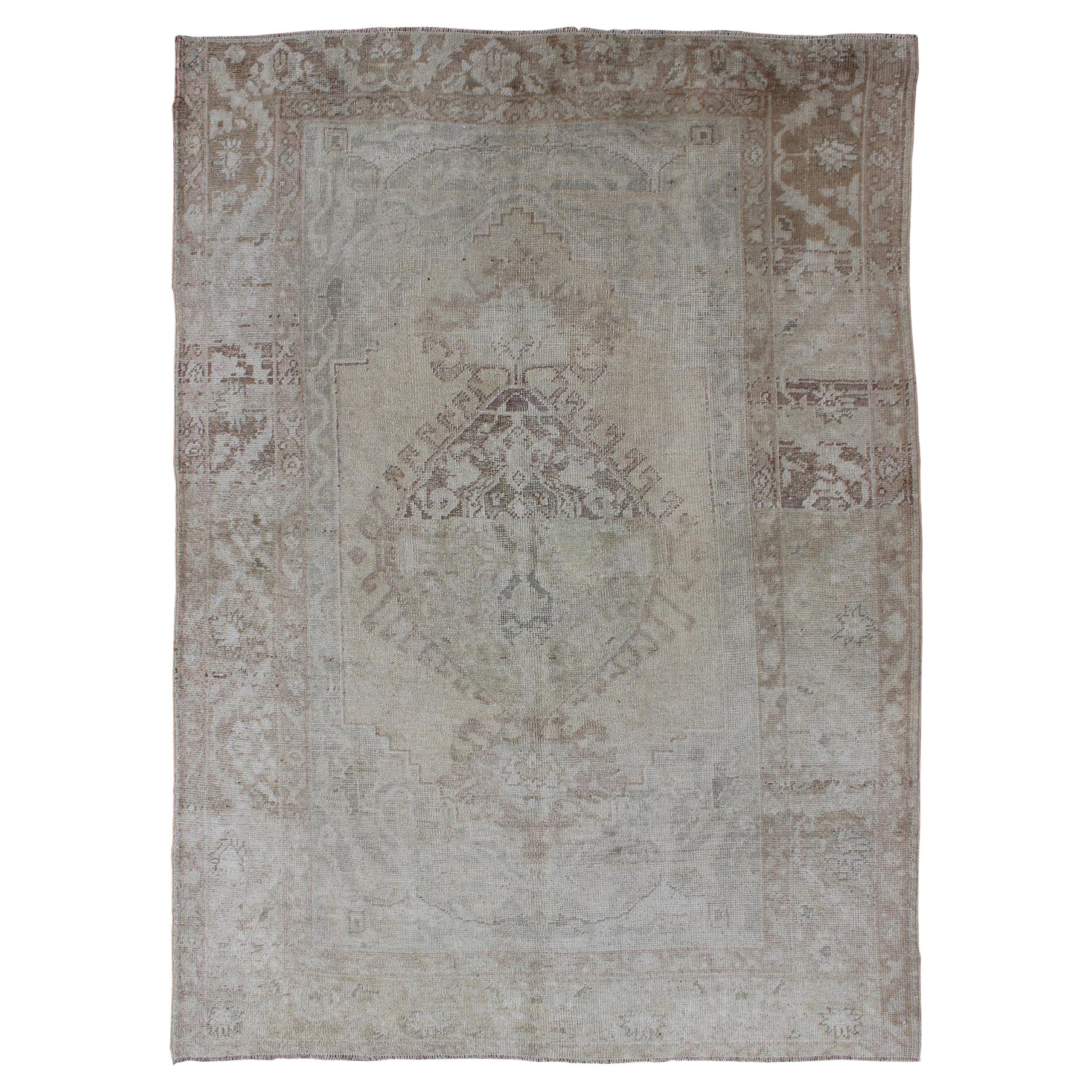 Earth Tones Antique Turkish Oushak Rug with Faded Colors in Medallion Design For Sale