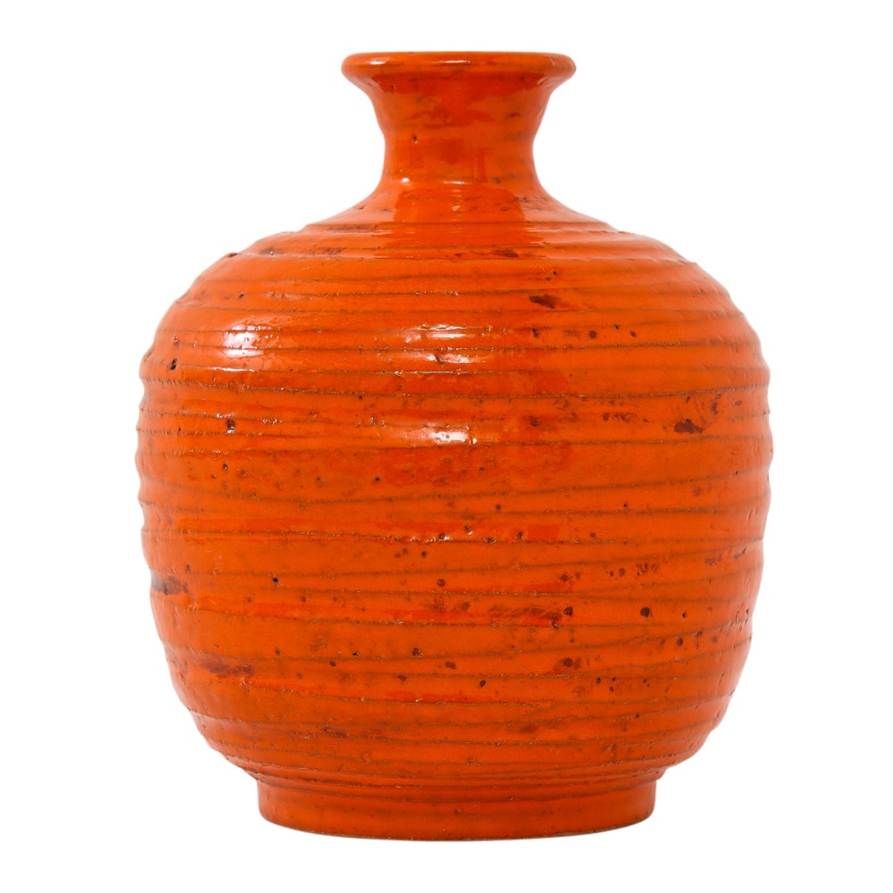 Rosenthal Netter vase, ceramic, orange, ribbed. Small vase from Bitossi's Pietra (Stone) decor series. The orange glazed body has deep relief ridges. Signed with paper label on the underside: 