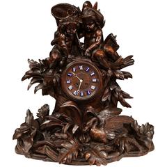 Large 19th Century Swiss Carved Walnut Black Forest Mantel Clock with Cherubs