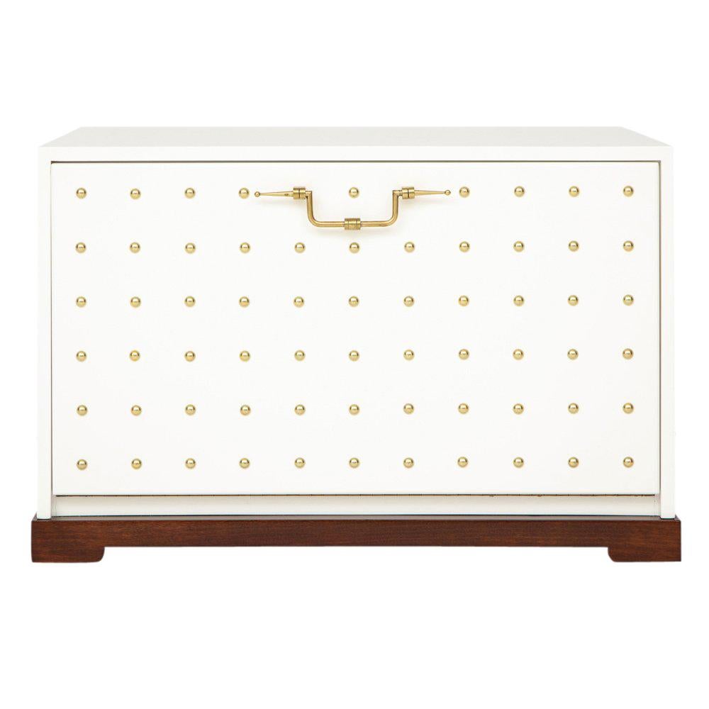 Tommi Parzinger, white lacquer and brass studded chest. Drop-front blanket chest which could additionally be used as an end table or nightstand. Appointed with a brass front pull and decorated with brass studs over a hand rubbed white lacquered