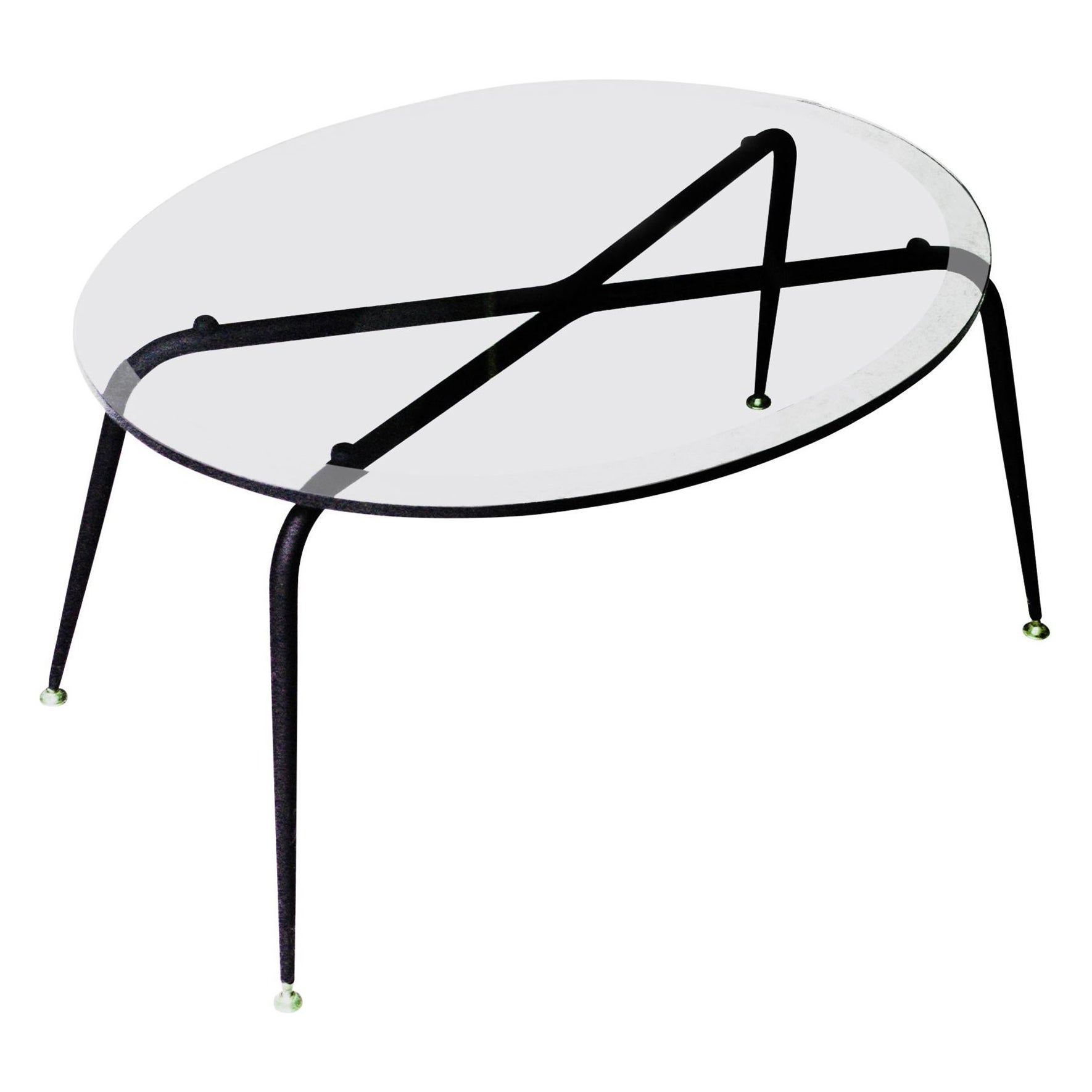 Coffee table with oval glass top and black lacquered metal base with pivoting brass pad supports.