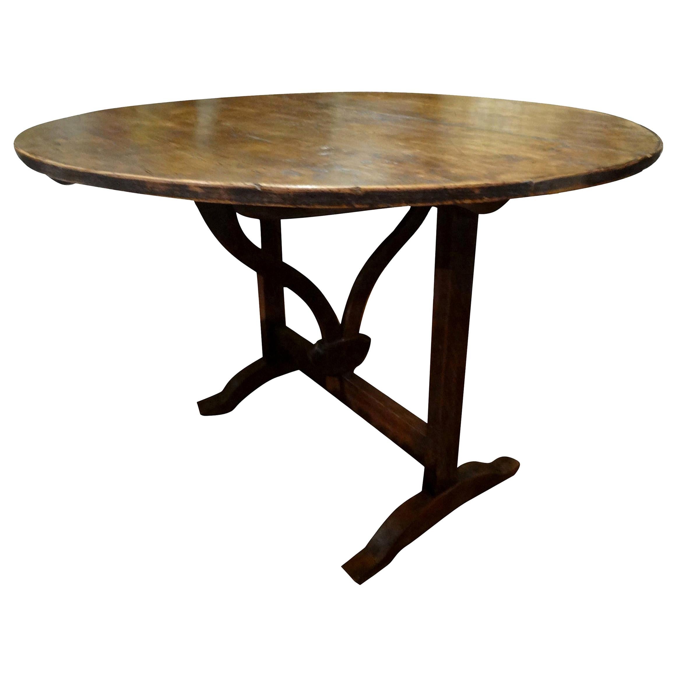 Offered is a 19th century French round walnut wine tasting table from the Burgundy Region of France.
Our French wine table has a rotating stretcher and trestle which supports the tabletop when in use. This walnut wine table can be folded
for