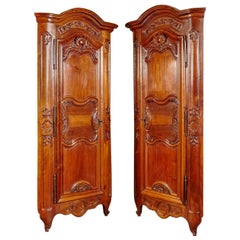 Pair of 18th Century Louis XV Carved Walnut Corner Cabinets from Lyon