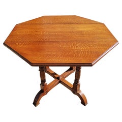 Gillows, an Aesthetic Movement Oak Octagonal Drop-Leaf Centre Table with Florets