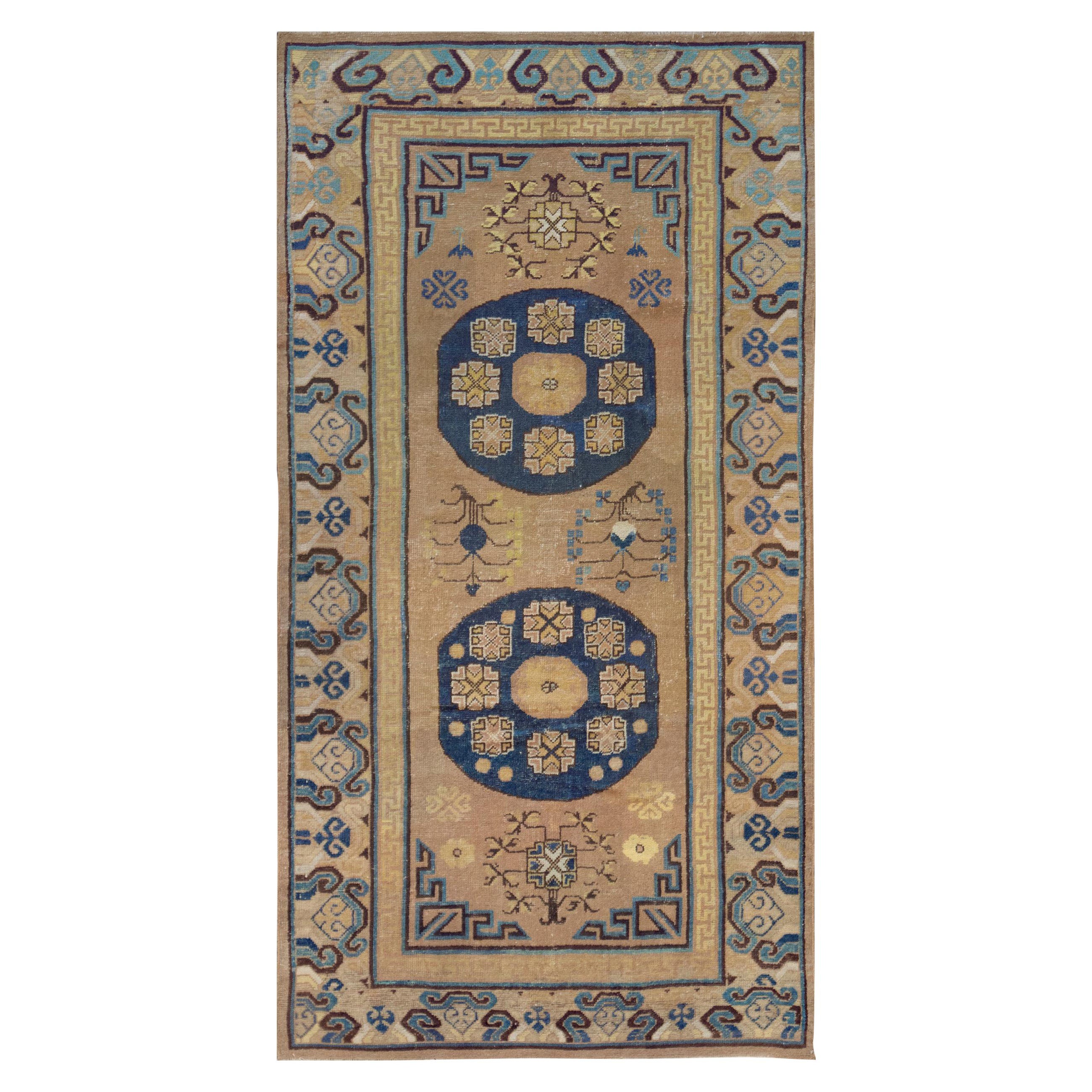 Antique Handwoven Wool Khotan Runner For Sale