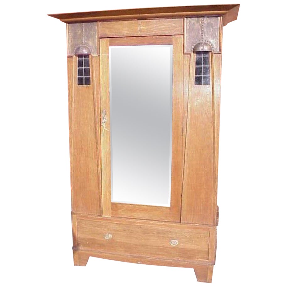 Maple & Co, An English Arts & Crafts Oak Wardrobe with Decorative Copper Details