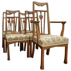 Liberty & Co., A Set of Five Arts & Crafts Oak Dining Chairs with Heart Details
