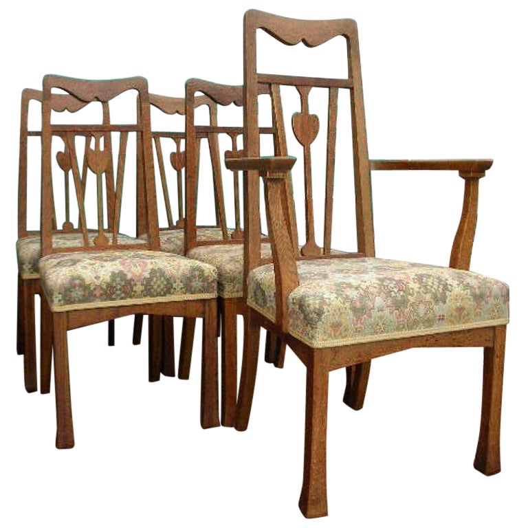 Liberty and Co., A Set of Five Arts and Crafts Oak Dining Chairs with