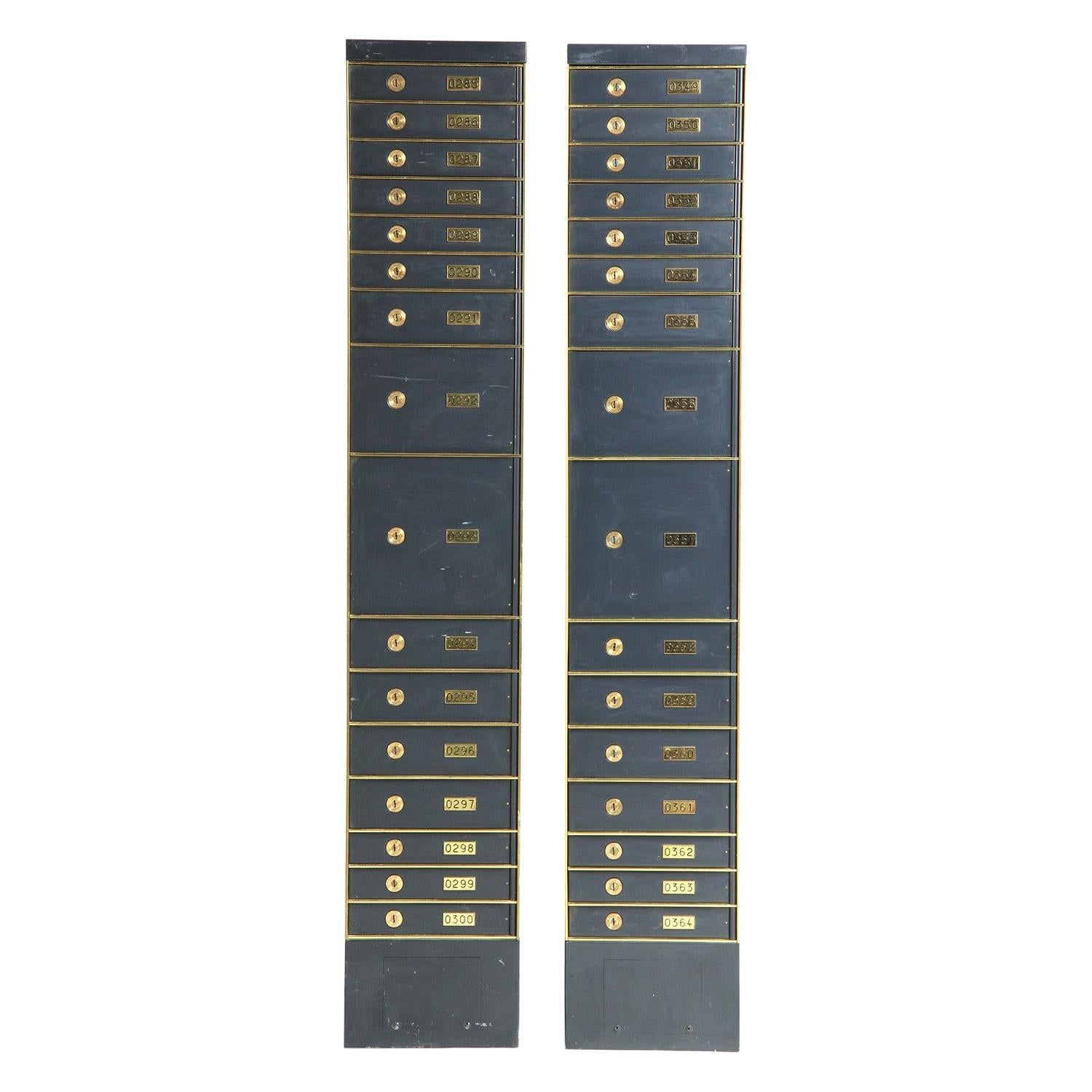 An unusually tall and narrow Industrial enumerated stacked safety deposit box finely crafted of painted steel with brass details. Made in the USA, circa 1950s.