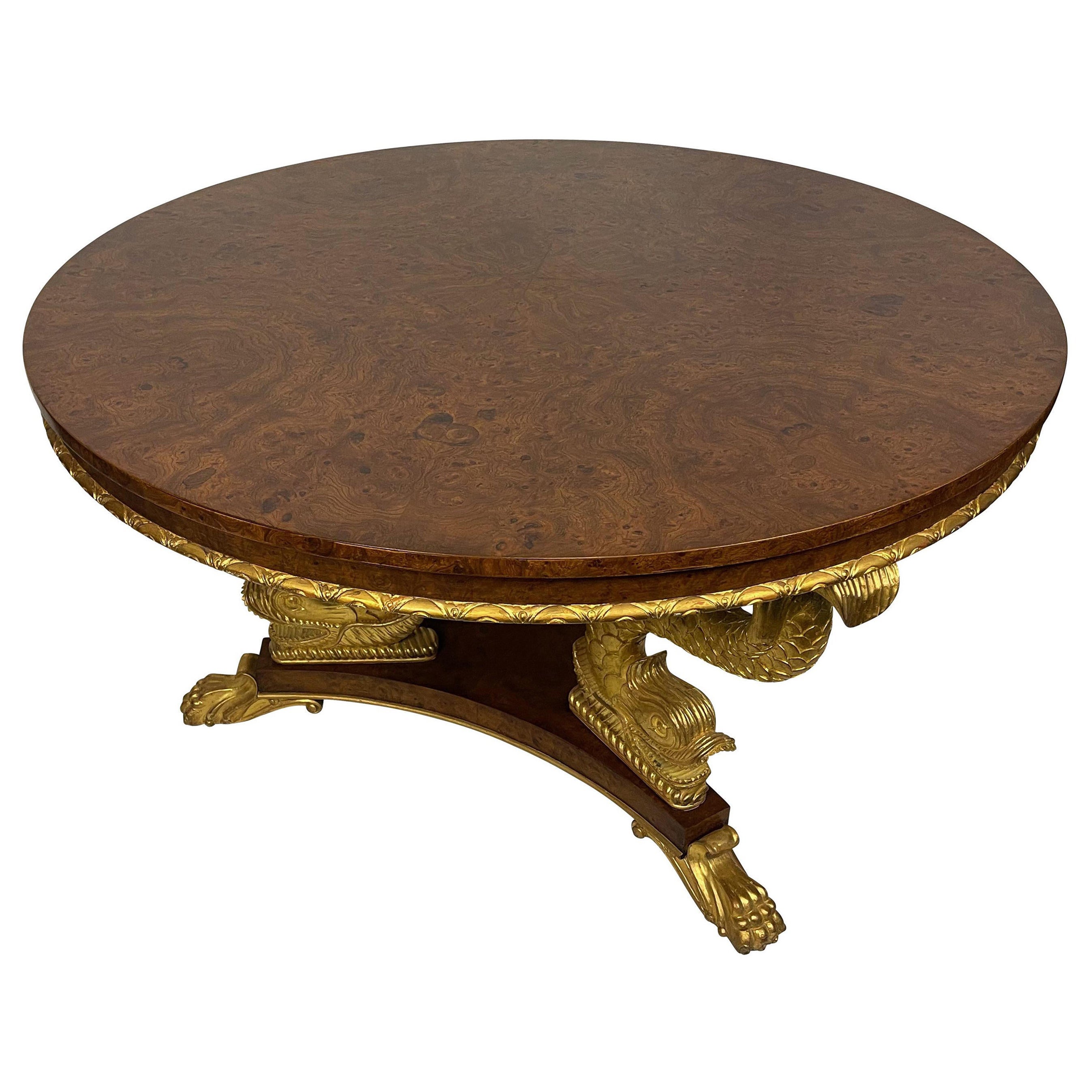 Gold gilt and light burled wood dolphin base center table. Exquisitely carved, and the burlwood surface has been completely professionally refinished dolphin base center table. Great quality and finely carving signed Smith and Watson since 1907.