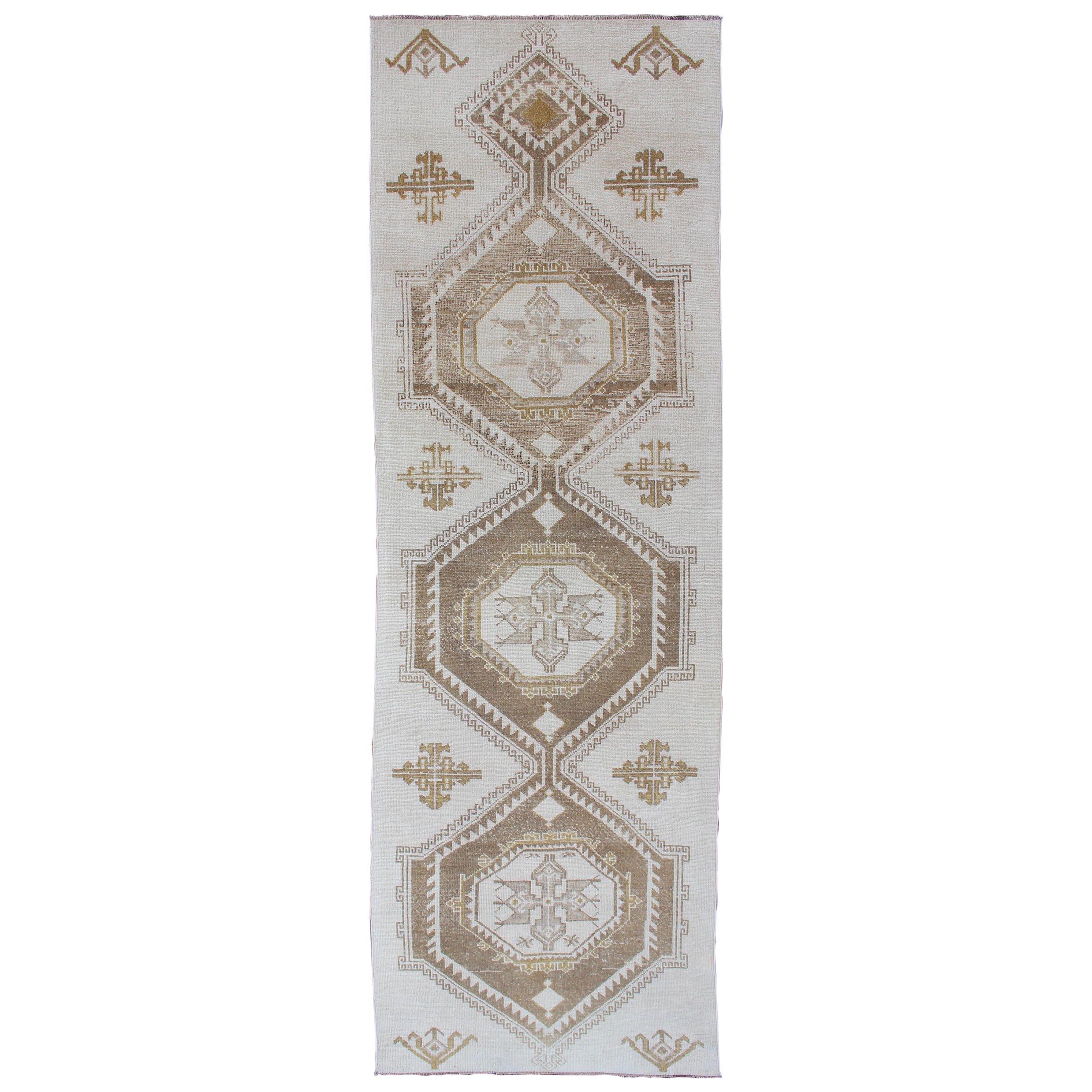 Subdued Vintage Turkish Oushak Runner with Medallions in Cream and Brown For Sale