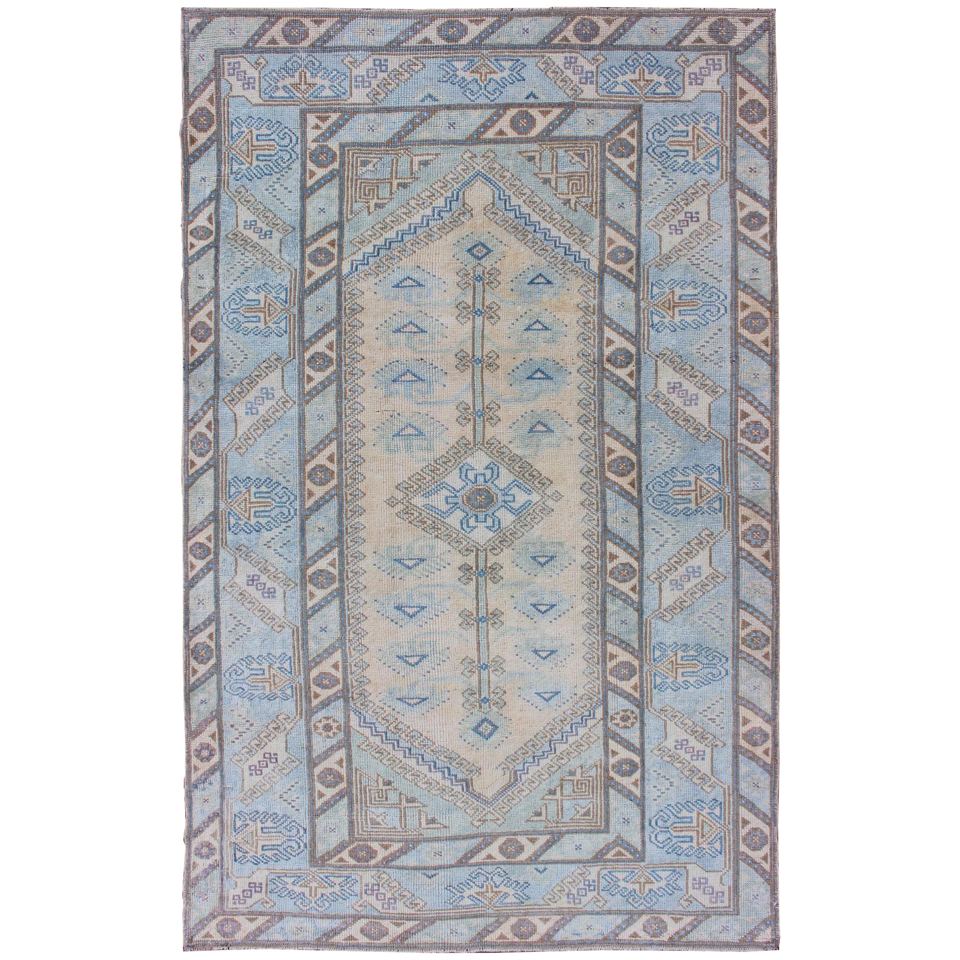 Faded Oushak Rug from Turkey with All Over Design in Blues and Cream For Sale