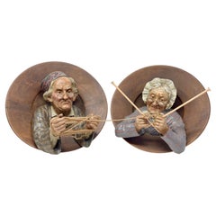 Pair Antique German Enamel Carved Wall Plaques "Knitting Couple" Circa 1890-1910