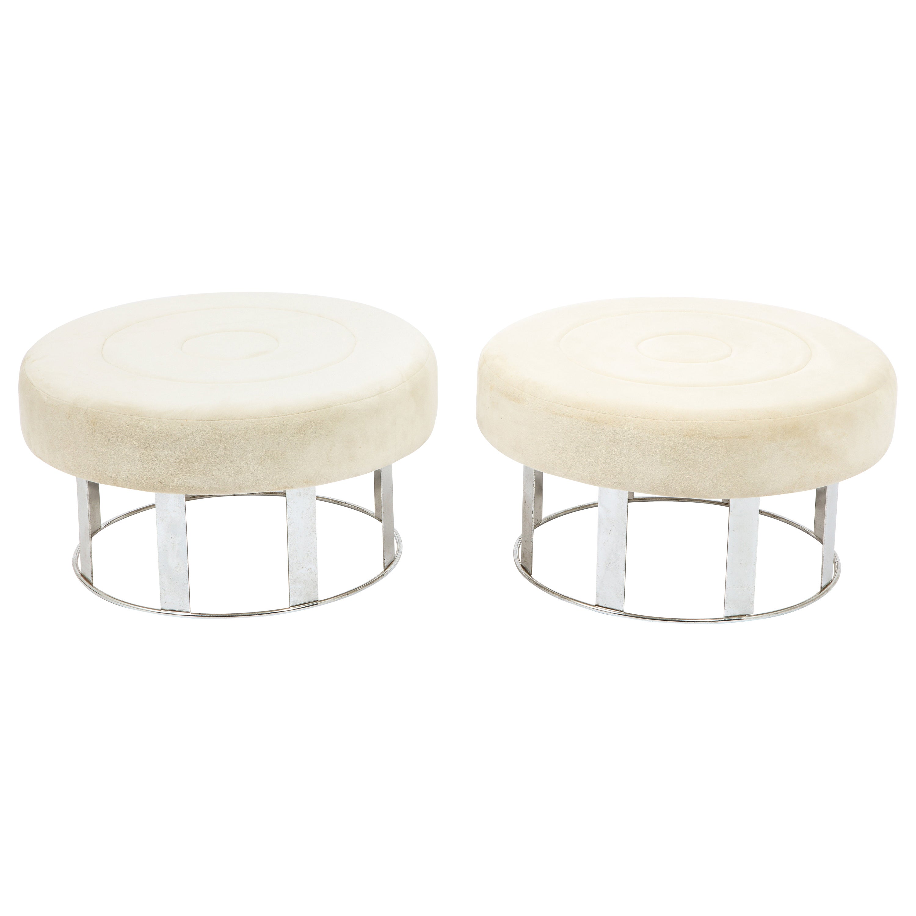 Most likely a custom order, a pair of large and comfortable ottomans in white velvet on windowed chrome bases.