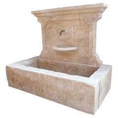 Carved French Stone Wall Fountain with Cast Iron Spout and Spill Bowl