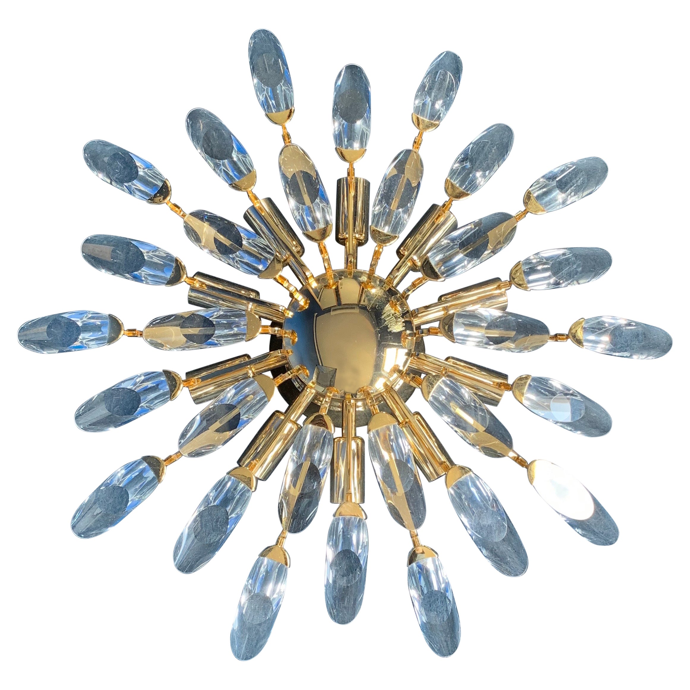 Palwa sunburst gilt metal flush mount with 10 candelabra sockets illuminating the clear crystal glass pieces.
Austria 1970.
Two available.
   