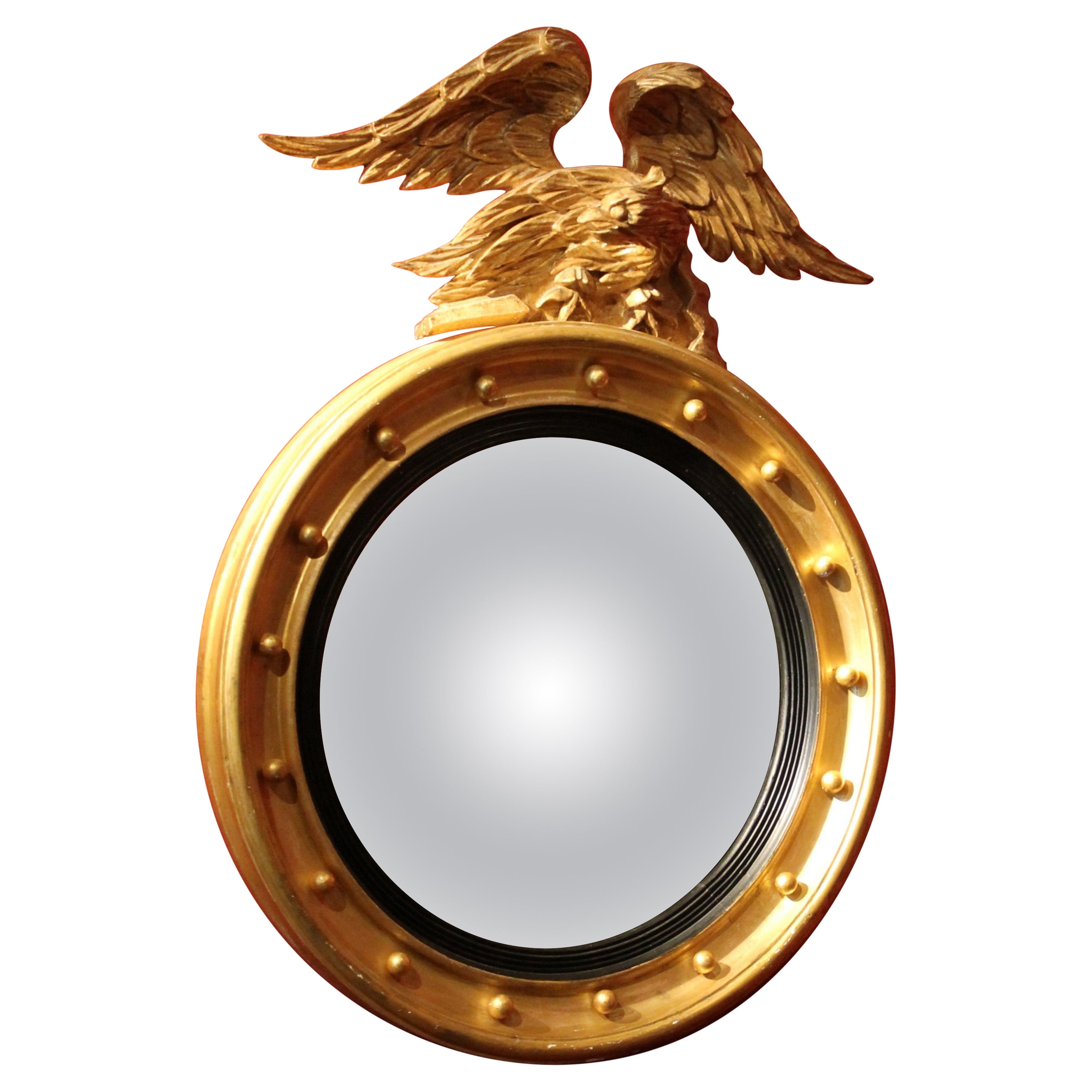 Italian Regency Round Giltwood and Ebonized Convex Mirror with Carved Eagle For Sale