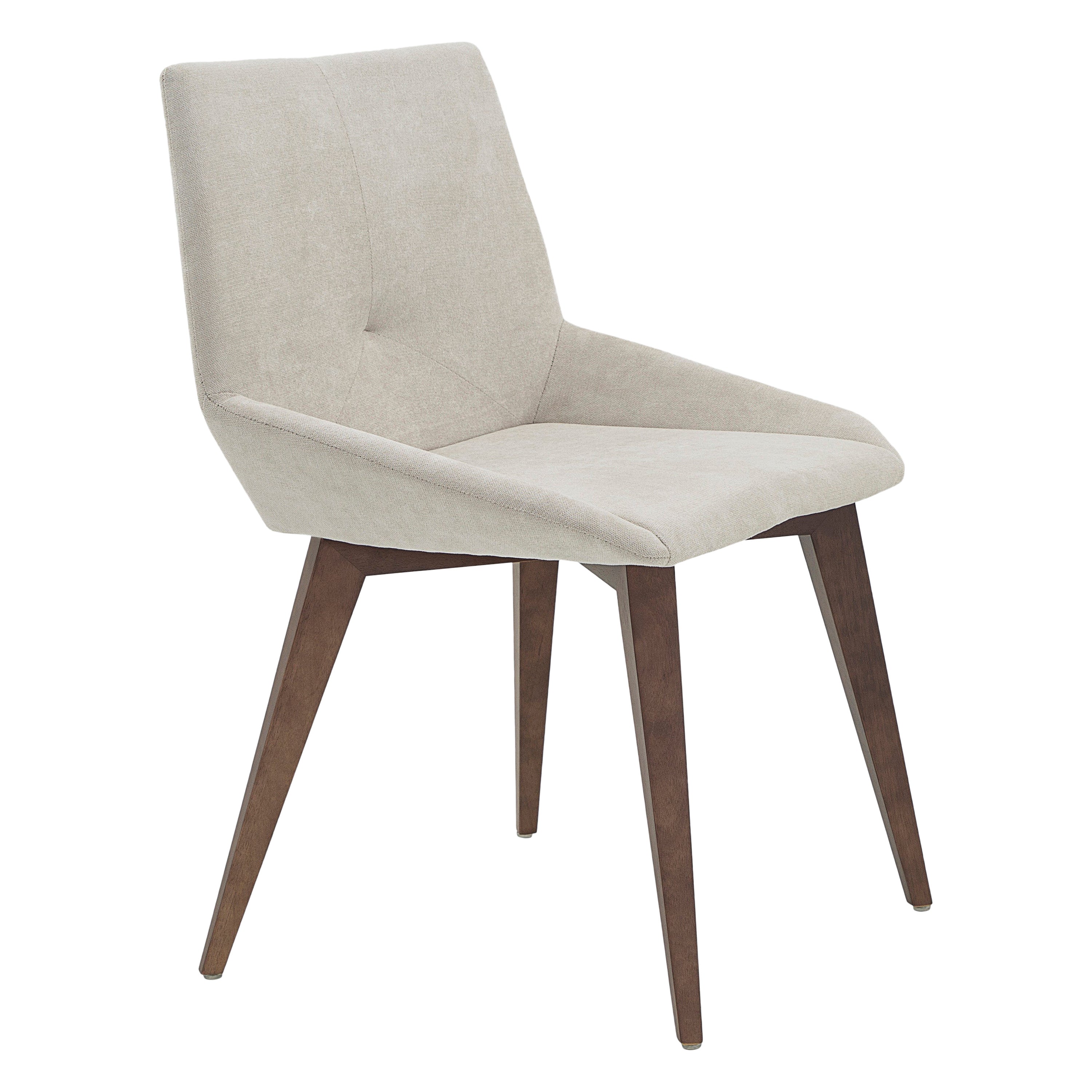 A Cubi dining room chair designed by Larissa Batista for Uultis, with geometric shaped back, walnut finish and light beige fabric. *Please check availability prior to purchase*.

The Cubi dining chair embodies refined modern design with its