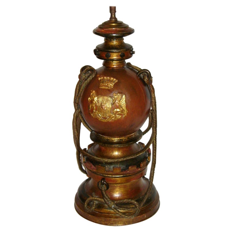A circa 1900 English nautical lamp with gilt metal rope on body and gilt coat of arms.

Measurements:
Height of Body: 20