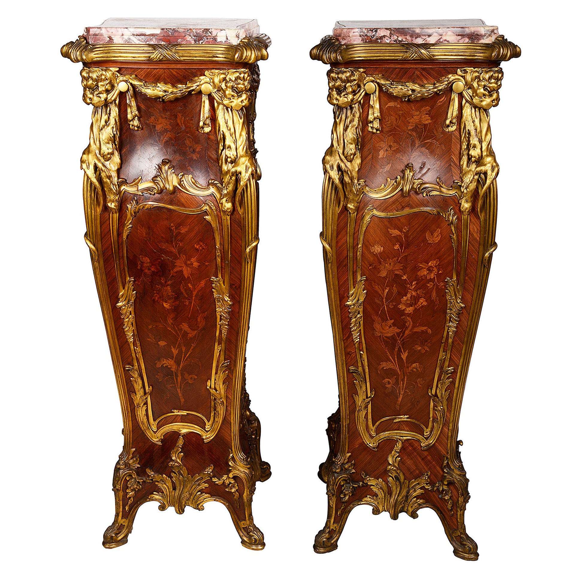 A fine quality and rare pair of late 19th century French Louis XVI style pedestals by Francoise Linke. 
Each having their original marble tops, wonderful gilded ormolu mounts depicting ribbons, swags, Lion masks and rococo mouldings. Inset floral