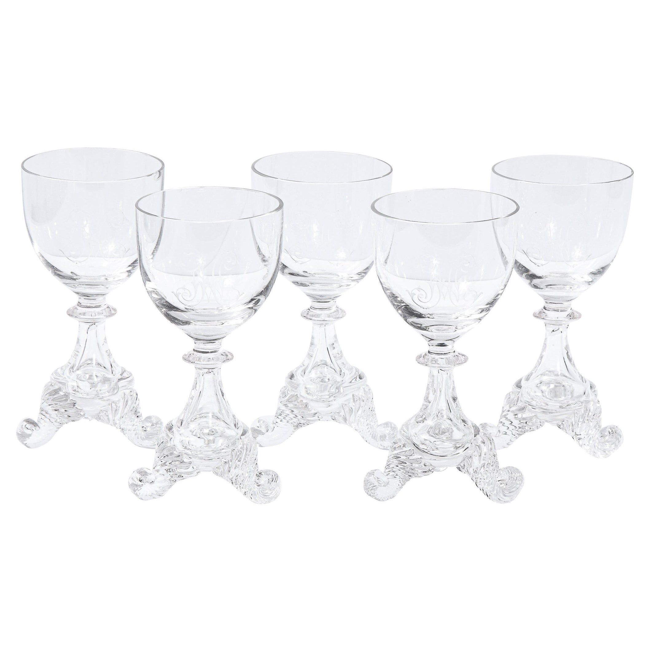 This beautiful set of four apertif/ liqueur glasses were realized in Sweden during the 19th Century. Each glass features sculptural striated curled feet that ascend into an amorphic volumetric gourd shaped body that tapers into a cylindrical neck