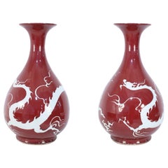 Pair of Chinese Burgundy and White Dragon Motif Vases