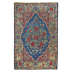Mini tapis traditionnel bleu de Kerman à motifs formels