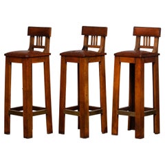 Three Craft Brutalist Full Leather Bar Stools with Brass Details from the 1940's