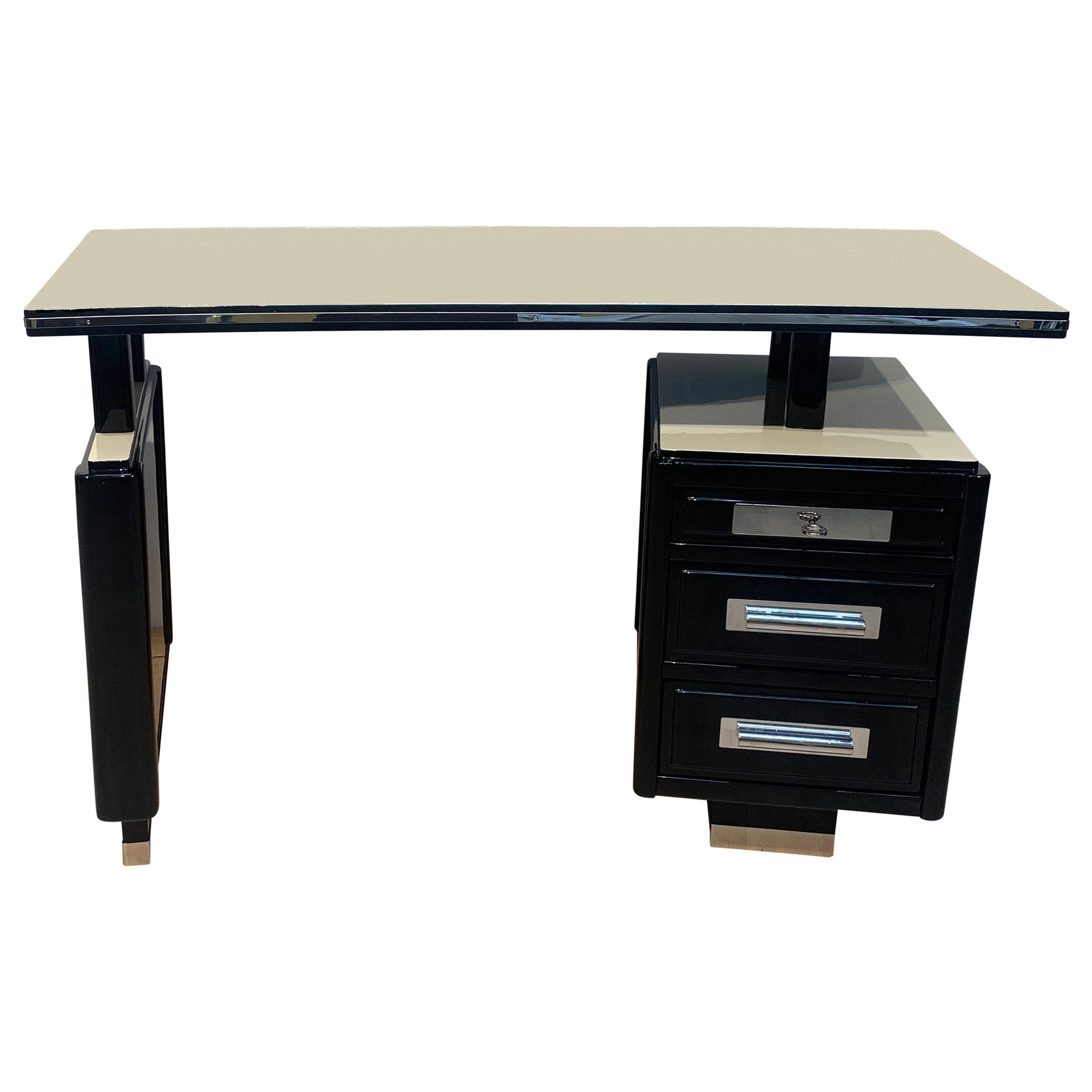 Small Art Deco desk, half-moon shaped, black and white lacquer, France circa 1940.

Oak, black and cream-colored high gloss piano lacquer.

Three drawers, with interesting locking mechanism: Only when the top drawer is slightly drawn outwards, the
