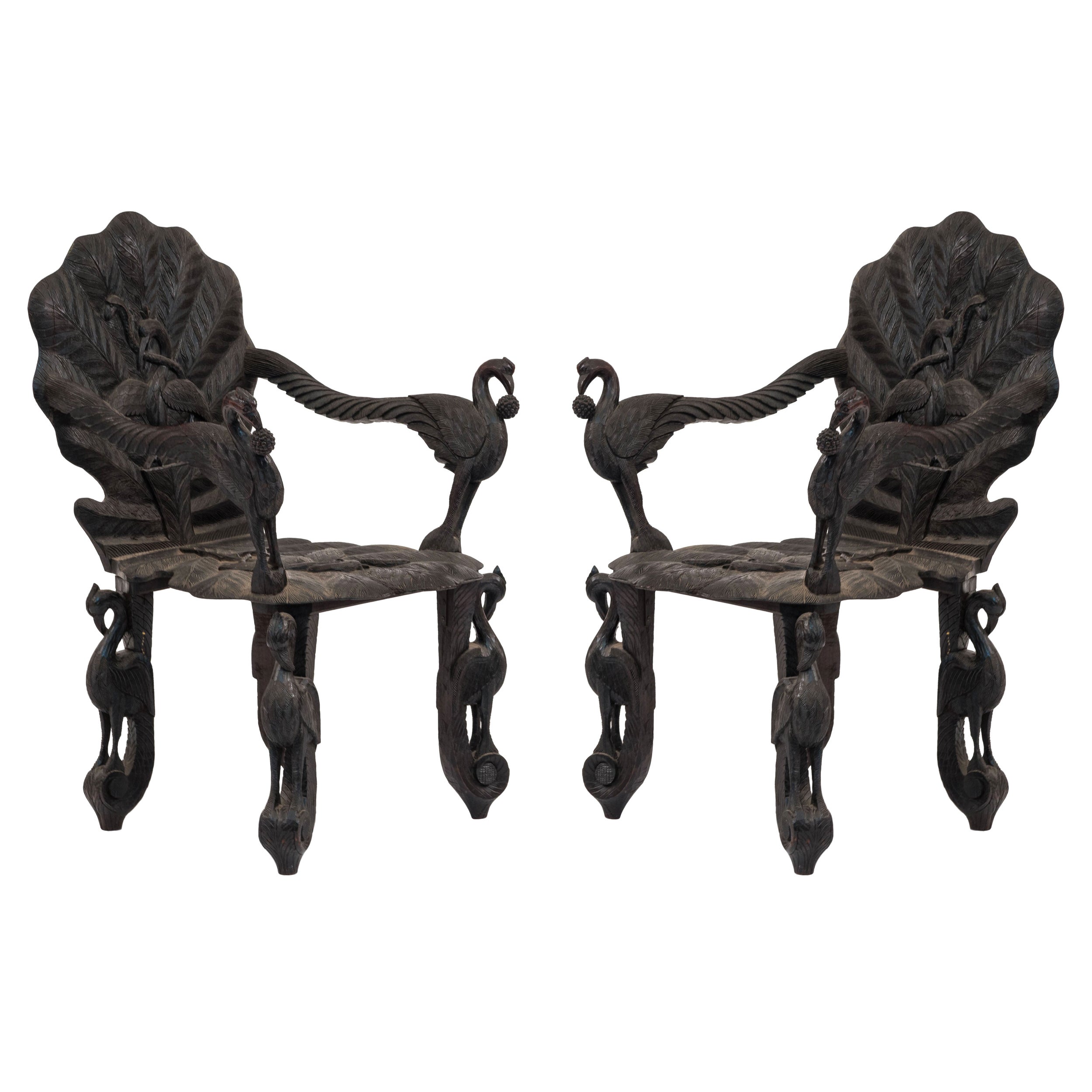 Pair of Burmese Ebonized Carved Leaf and Bird Design Armchairs For Sale