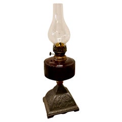 Antique Cranberry Glass Oil Lamp on Decorative Iron Base