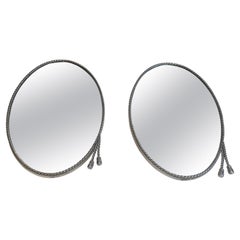 Attributed to Maison Bagués, Pair of Oval Silvered Mirrors with Twisted Garlands