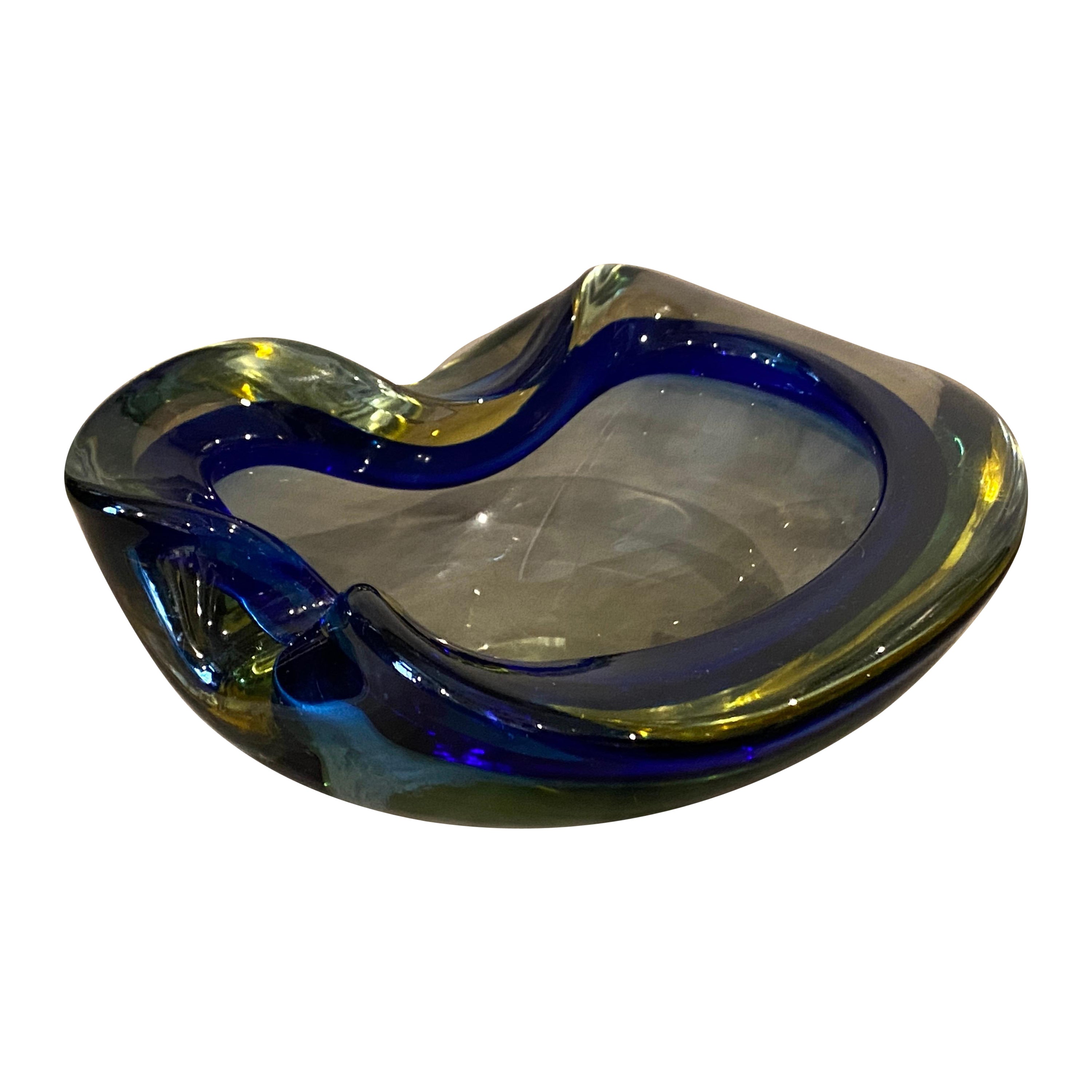 A blue and green sommerso murano glass ashtray by Flavio Poli manufactured in Murano in the Seventies, it's in perfect conditions.
This Bowl is a stunning example of Italian glass artistry, particularly associated with the renowned Murano