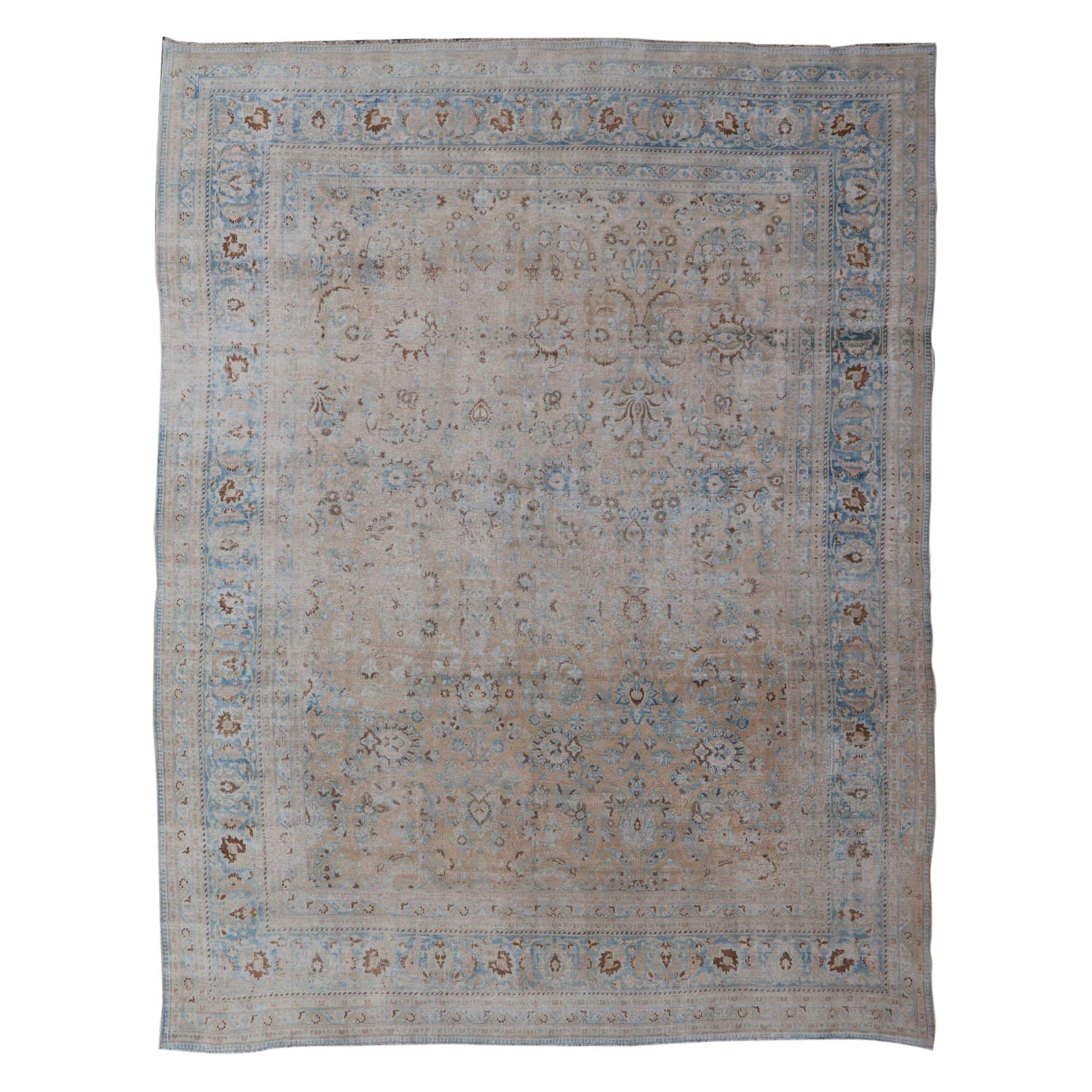 Distressed Persian Antique Mashhad Carpet with Muted Floral and Medallion Design For Sale