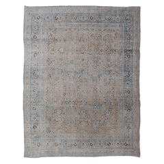Distressed Persian Antique Mashhad Carpet with Muted Floral and Medallion Design