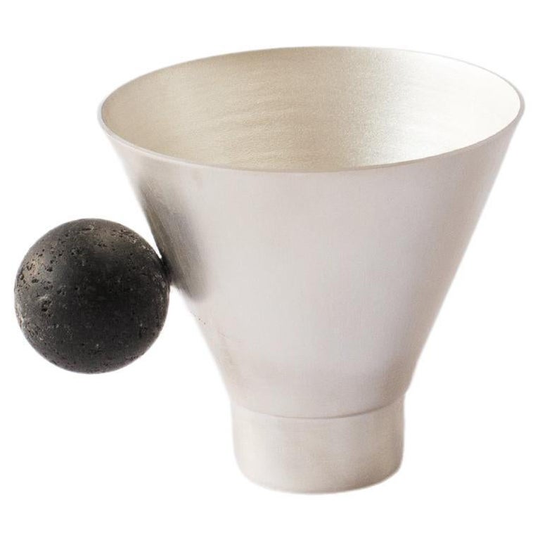 Elevate your daily tea or coffee ritual with our exquisite lava cup. Handcrafted with plated brass, its geometric silhouette narrows at the base for a sleek and minimal aesthetic. The exquisite stone handle in lava rock, introduces a touch of