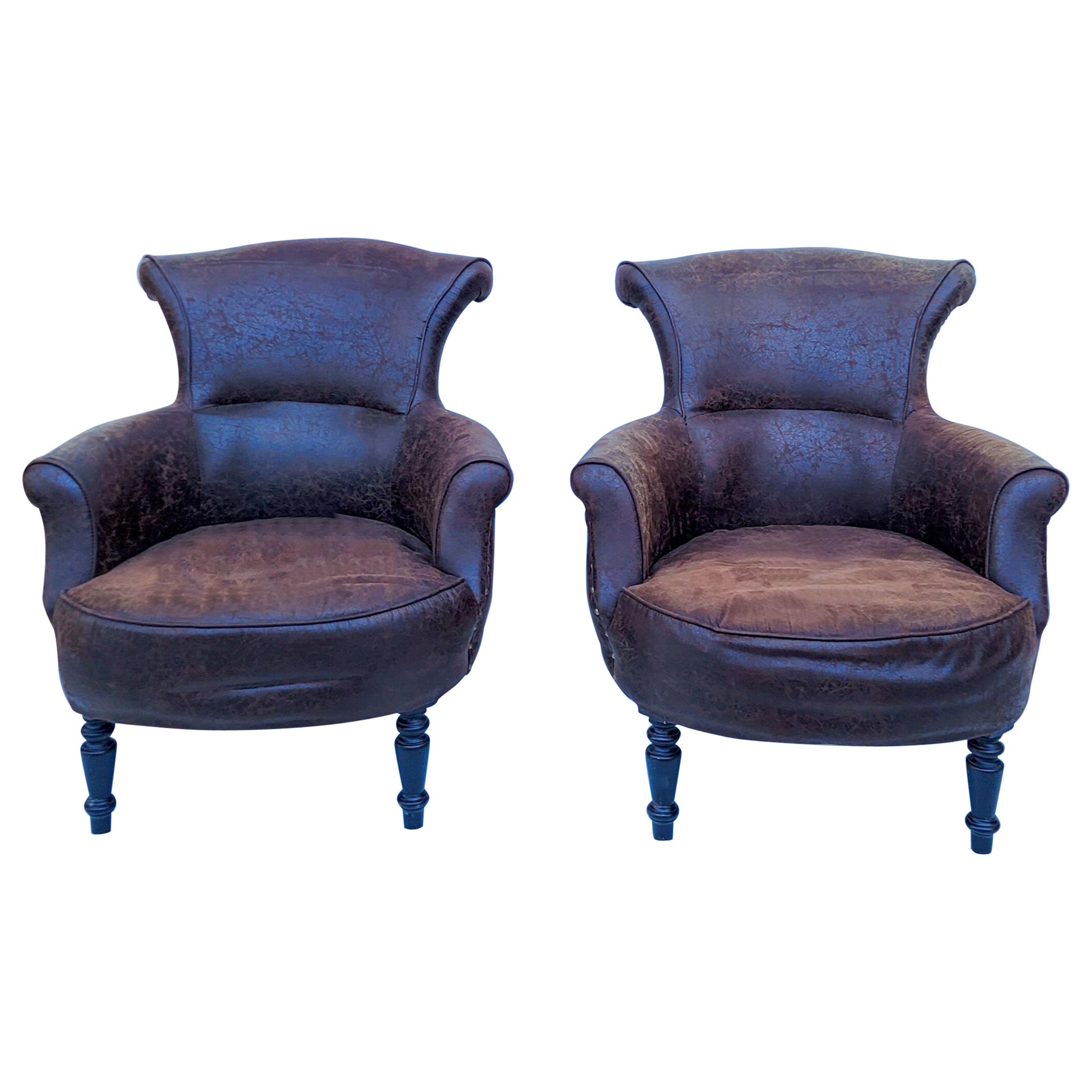 This is a great looking pair of distressed leather Ralph Lauren style club chairs. The legs are a turned ebony. They are unmarked. Seat 16”. Arm 21”.