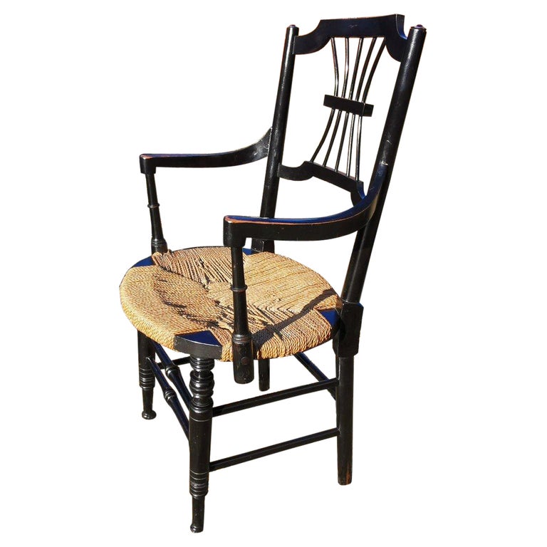 Liberty & Co. an English Aesthetic Movement Ebonised Armchair with Seagrass Seat For Sale