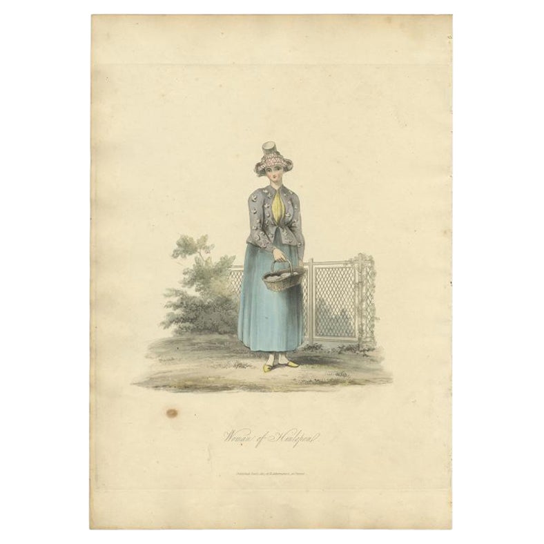 Antique costume print titled 'Woman of Hinlopen'. Old costume print depicting a woman of Hindeloopen, located in Dutch province 'Friesland'. This print originates from 'The Costume of the Netherlands displayed in thirty coloured engravings'.